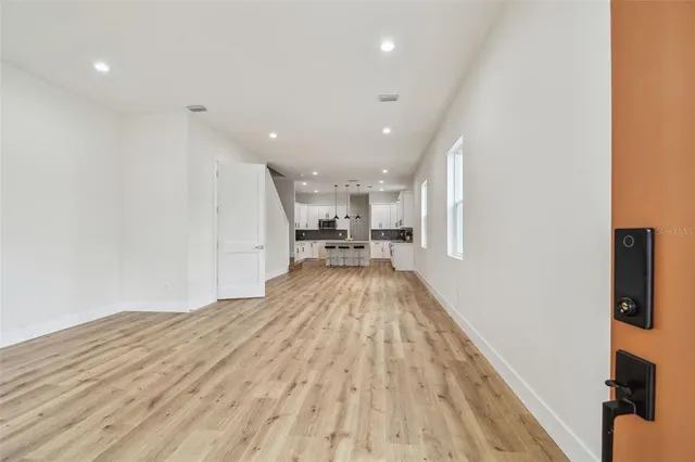 a view of kitchen with cabinets and wooden floor