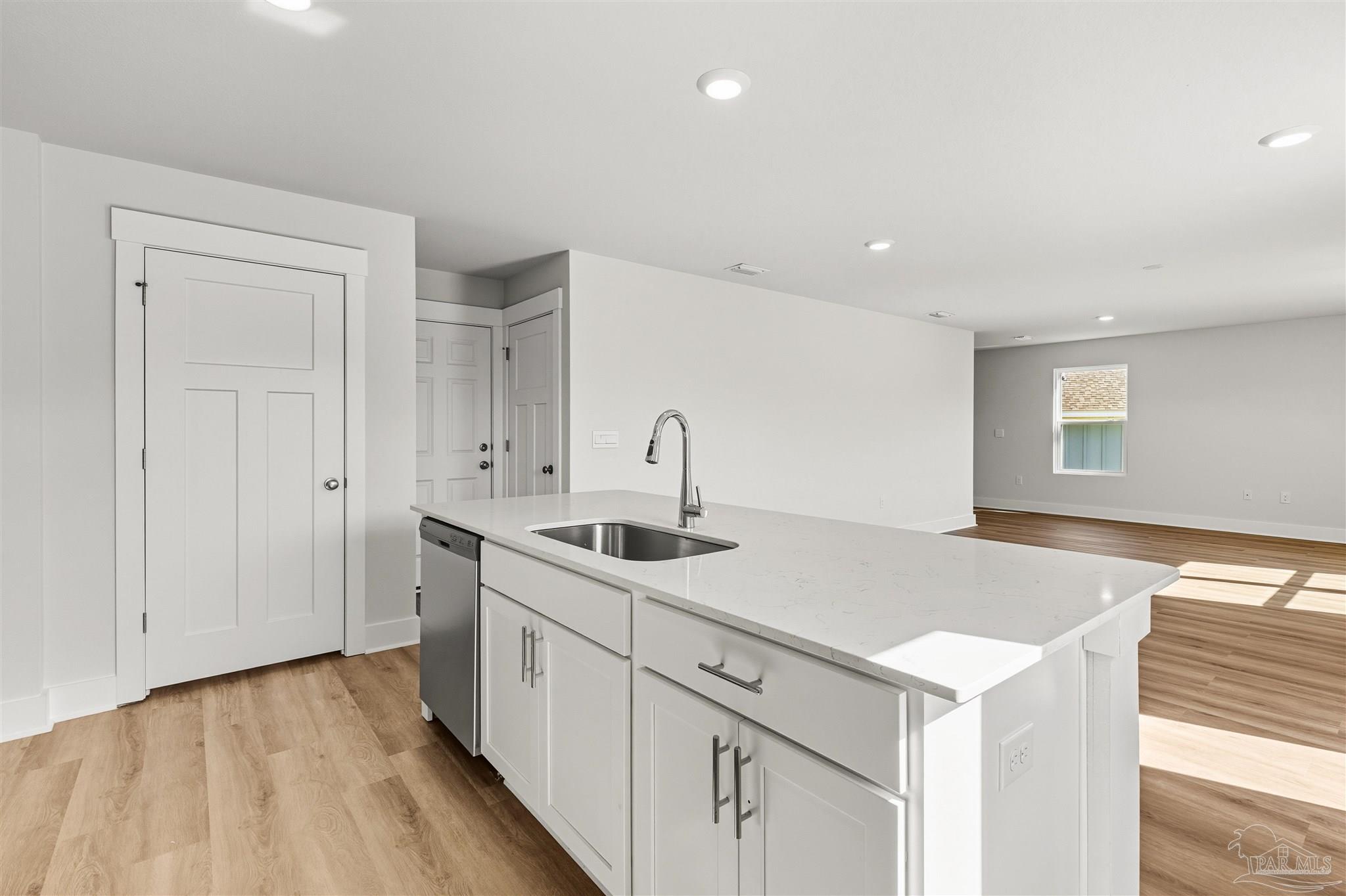 3162 Serviceberry Road Cantonment, FL 32533 - Photo 12 of 35 a kitchen with a sink and cabinets