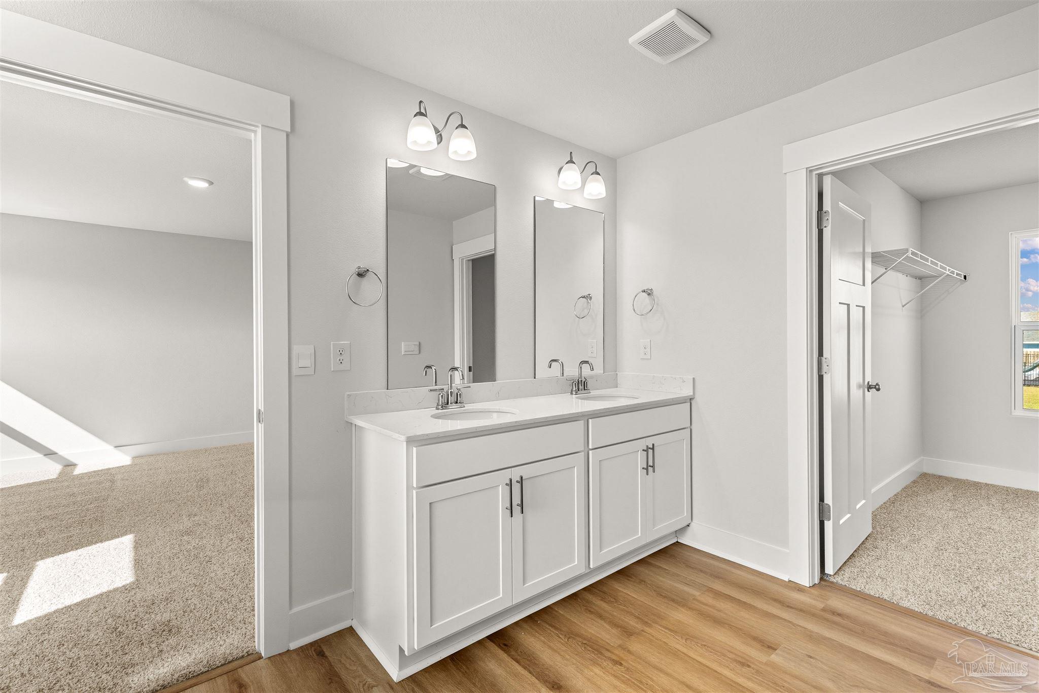 3162 Serviceberry Road Cantonment, FL 32533 - Photo 19 of 35 a bathroom with a double vanity sink and mirror