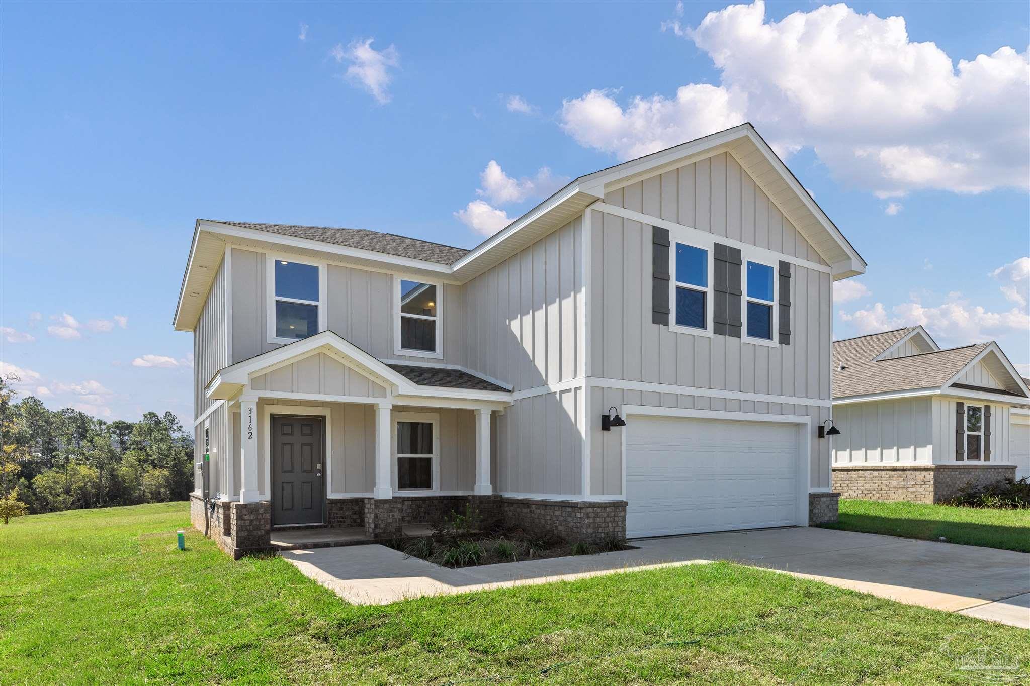 3162 Serviceberry Road Cantonment, FL 32533 - Photo 2 of 35 a front view of a house with a yard