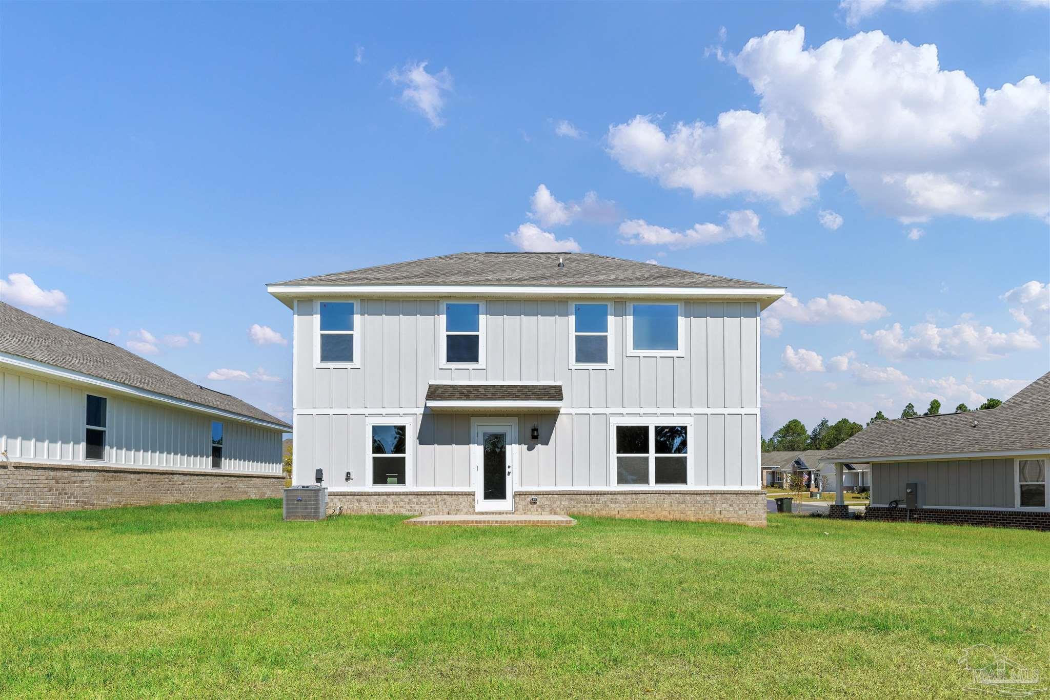3162 Serviceberry Road Cantonment, FL 32533 - Photo 30 of 35 a front view of a house with a garden