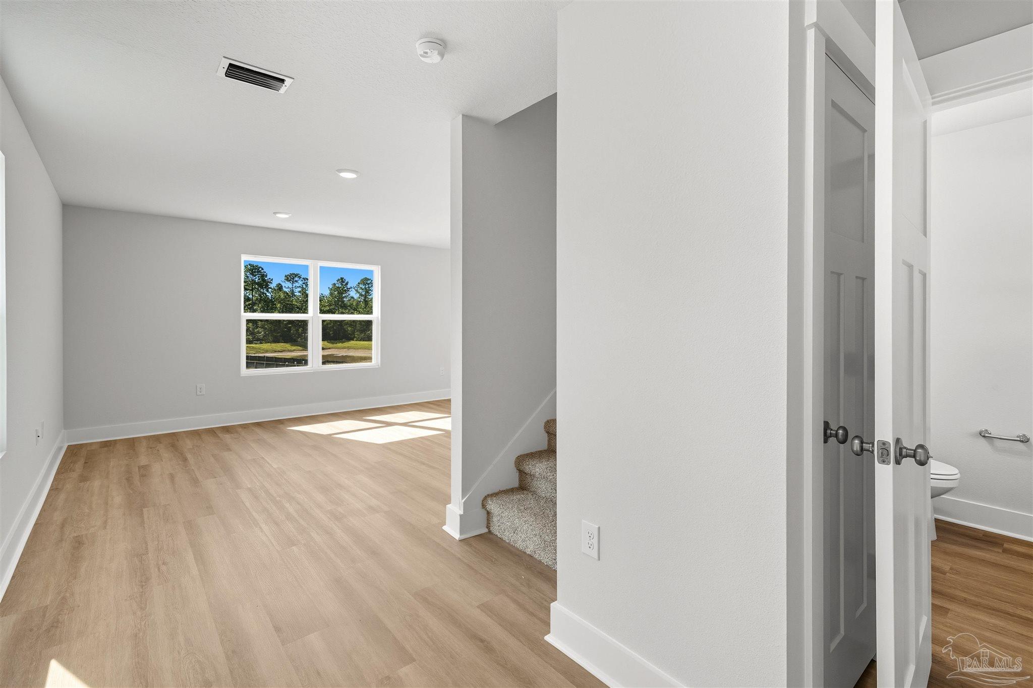 3162 Serviceberry Road Cantonment, FL 32533 - Photo 5 of 35 an empty room with wooden floor and a window