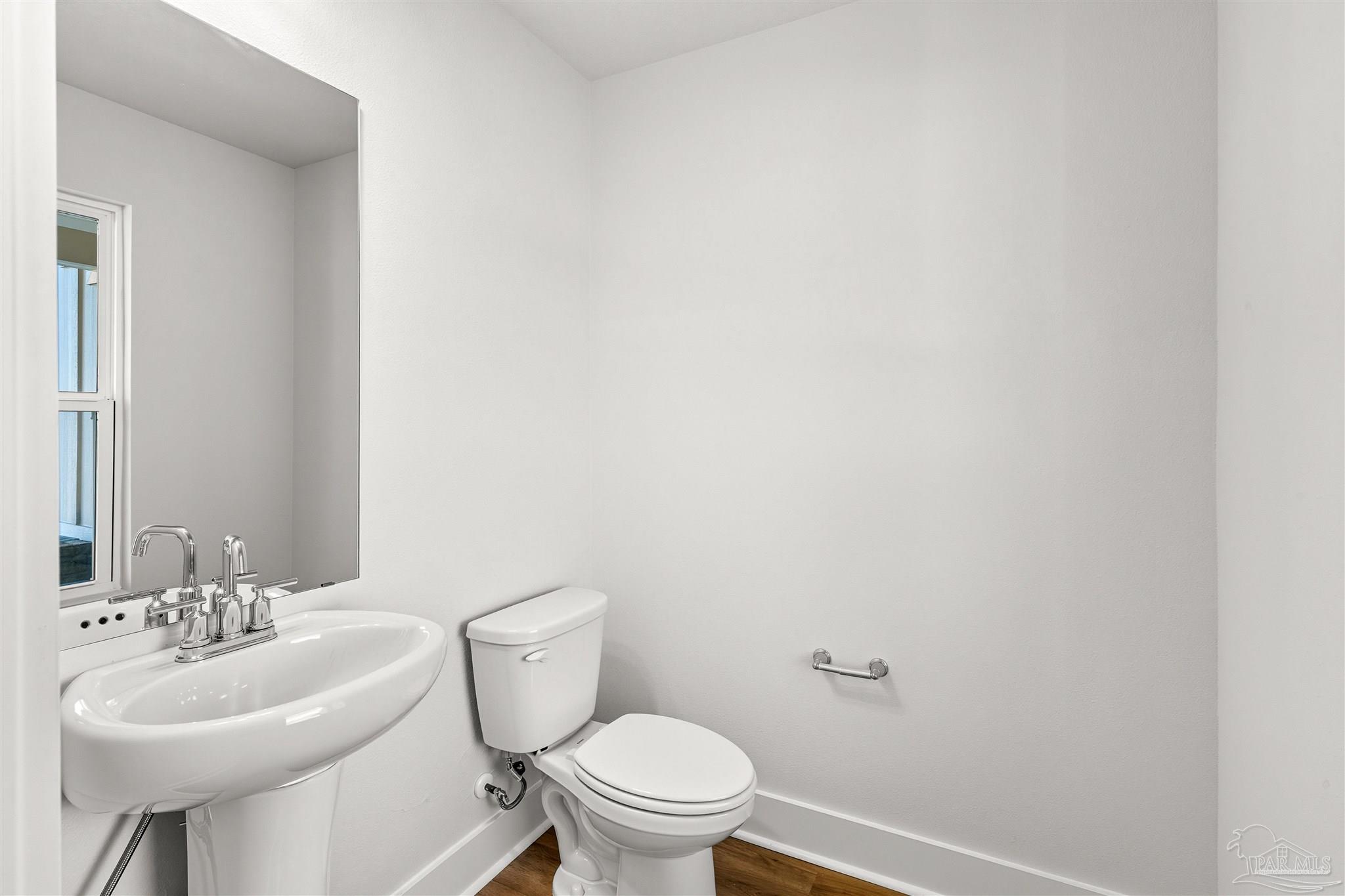 3162 Serviceberry Road Cantonment, FL 32533 - Photo 6 of 35 a bathroom with a sink a toilet and a mirror