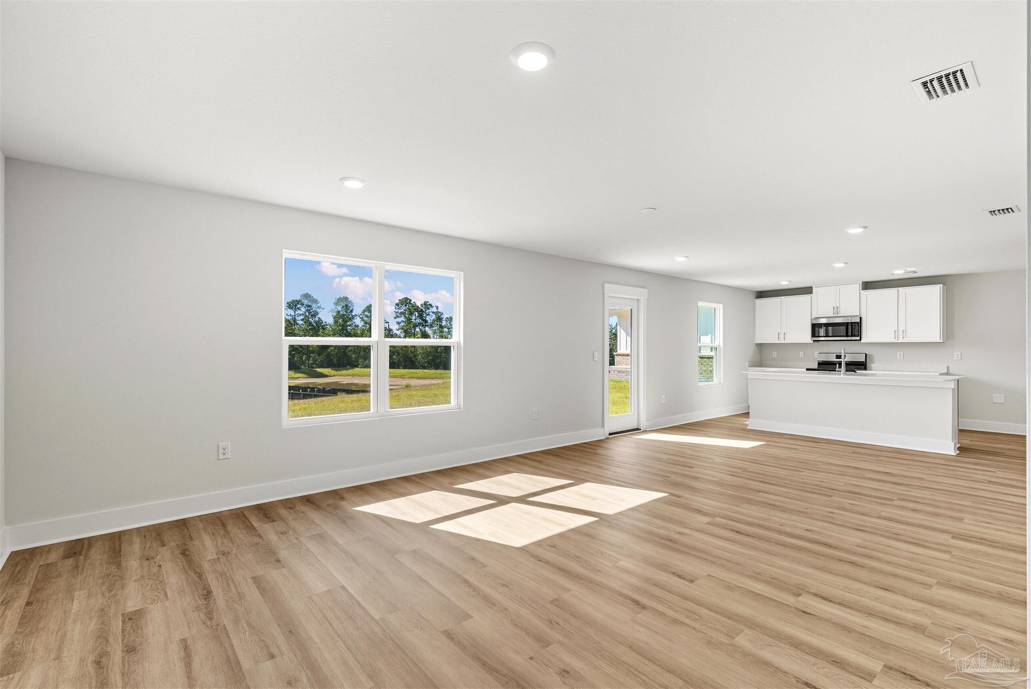 3162 Serviceberry Road Cantonment, FL 32533 - Photo 7 of 35 a view of an empty room with wooden floor and a window