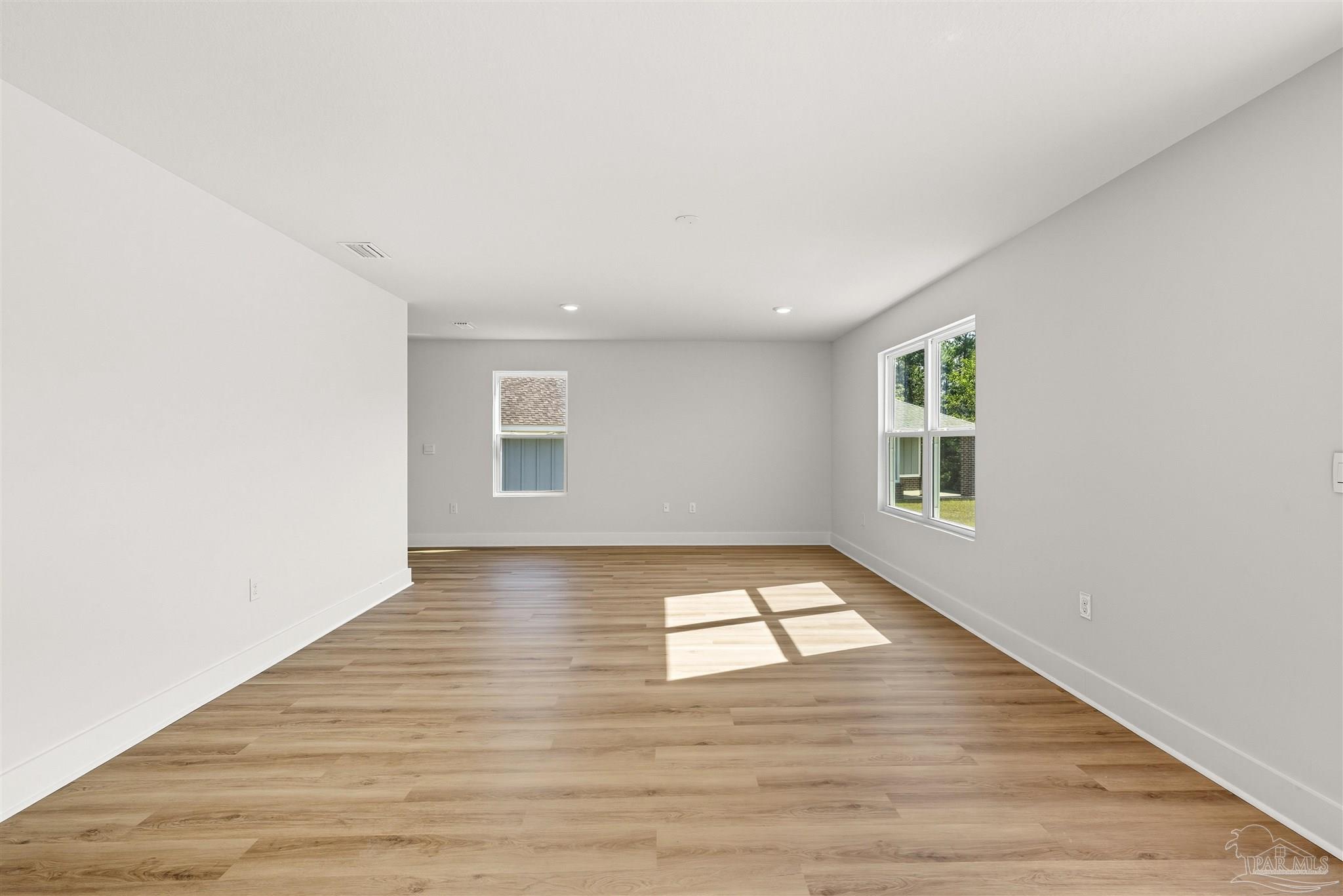 3162 Serviceberry Road Cantonment, FL 32533 - Photo 9 of 35 an empty room with wooden floor and windows