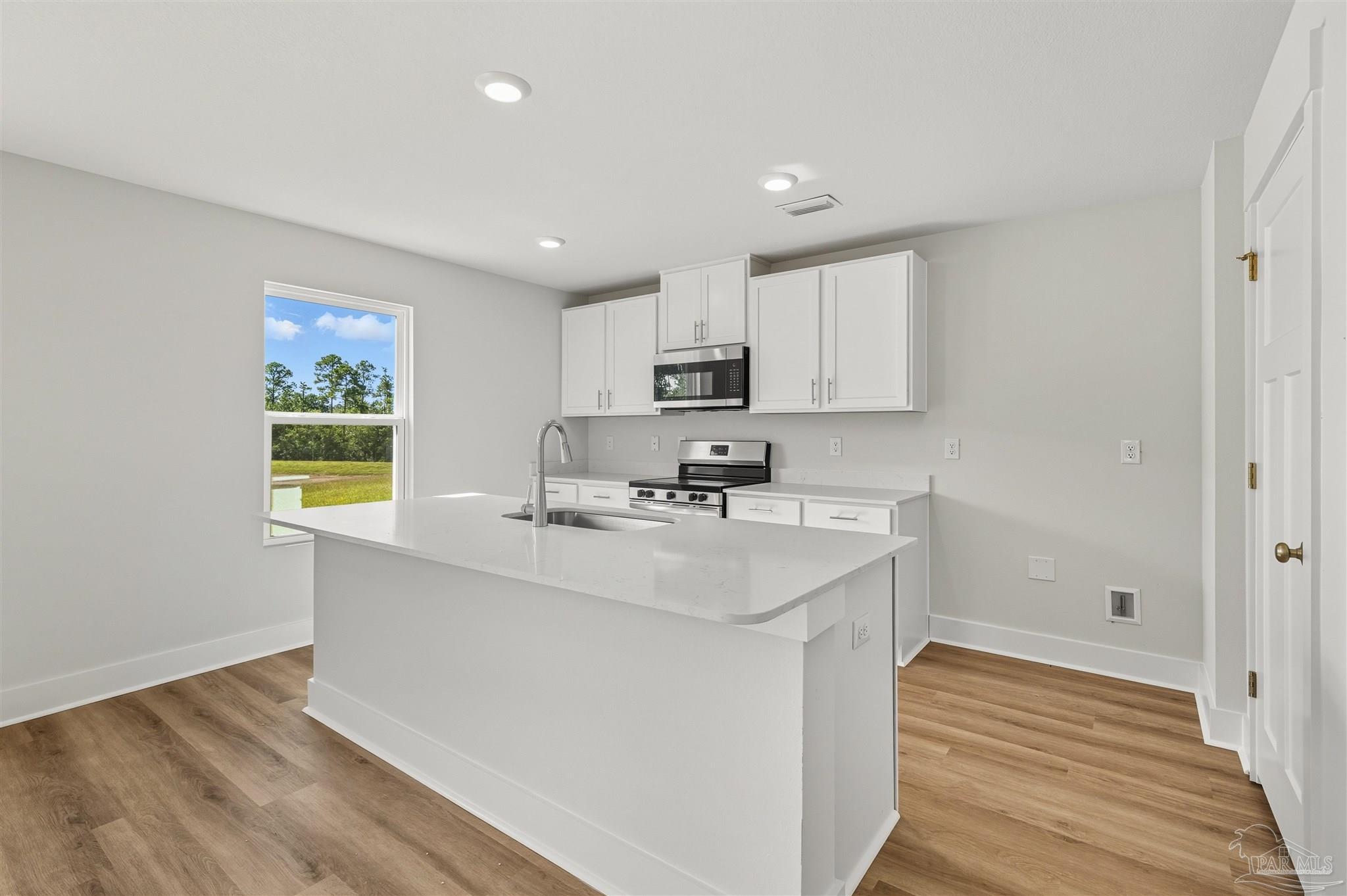 3162 Serviceberry Road Cantonment, FL 32533 - Photo 10 of 35 a kitchen with stainless steel appliances granite countertop a sink stove and refrigerator