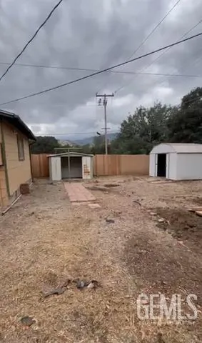 a view of a house with a backyard