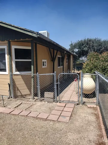 a view of house with backyard space and seating area