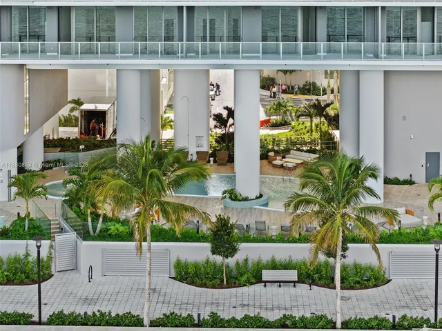 a front view of a house with plants