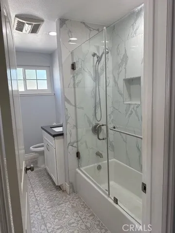 a bathroom with a shower a toilet and a shower