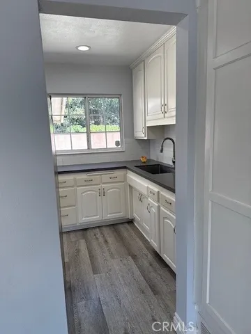 a kitchen with a sink cabinets and window