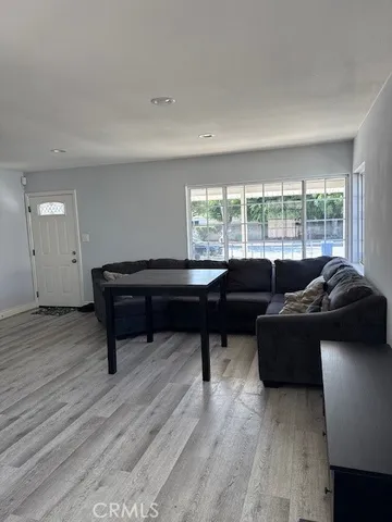 a living room with furniture and a piano