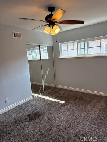 a room that has a fan and a window