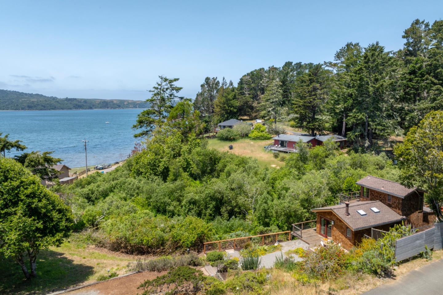 a view of a garden with lawn chairs under an umbrella