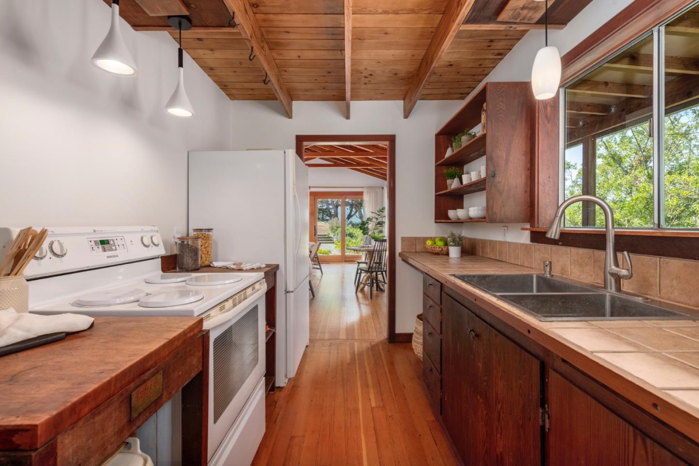 18050 Highway 1 Marshall, CA 94940 - Photo 13 of 65 a kitchen with stainless steel appliances granite countertop a sink a stove and a wooden floors
