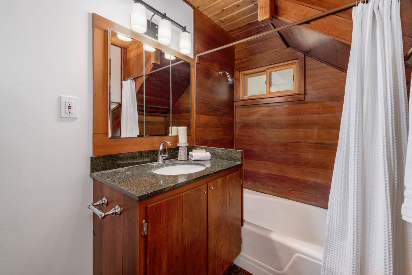 18050 Highway 1 Marshall, CA 94940 - Photo 22 of 65 a bathroom with a granite countertop sink and a mirror
