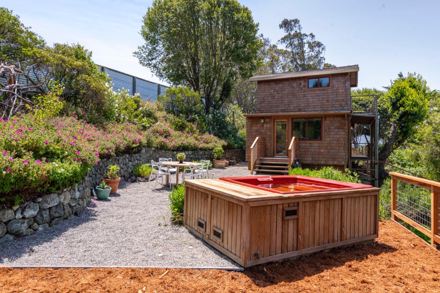 18050 Highway 1 Marshall, CA 94940 - Photo 53 of 65 a table and chairs in front of a house