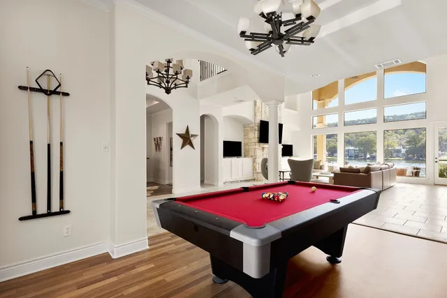 a room with pool table table soccer and a chandelier