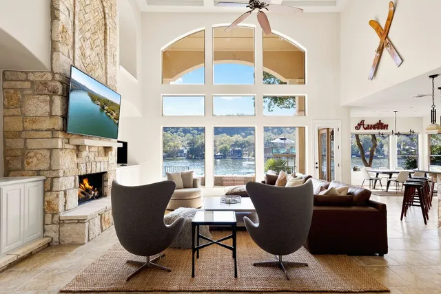 a living room with fireplace furniture dining table and a fireplace