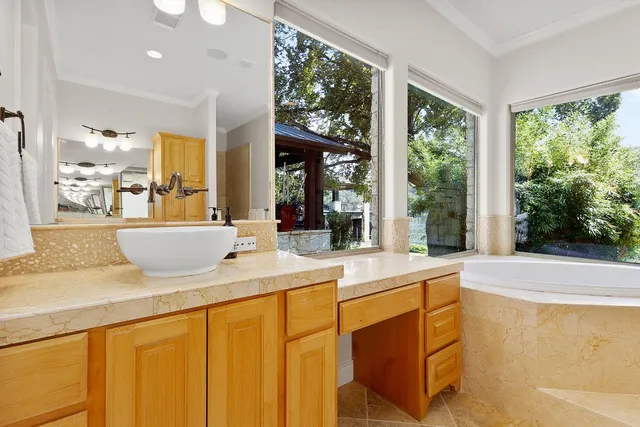 a living room with stainless steel appliances granite countertop furniture and a large window