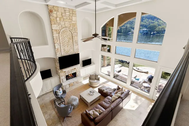 a living room with furniture and floor to ceiling windows