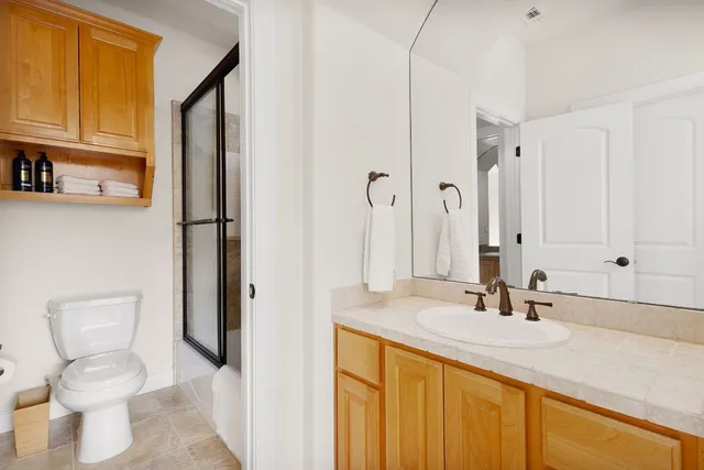 a bathroom with a sink toilet and shower