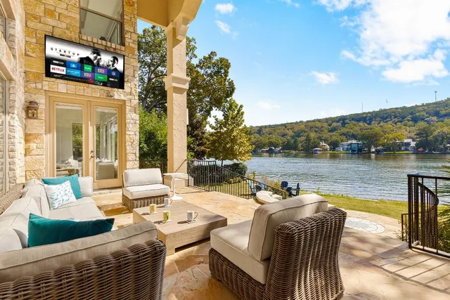 a view of a patio with couches chairs and a table with garden view
