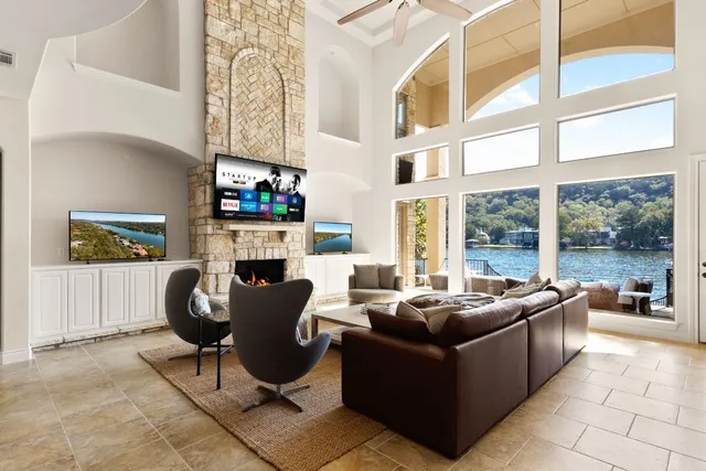 a living room with fireplace furniture and a large window