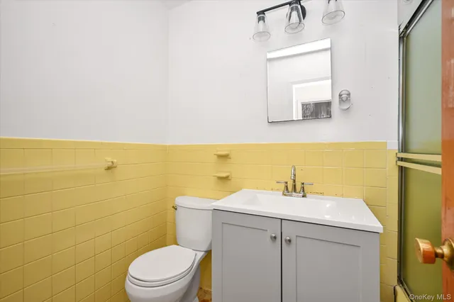 a bathroom with a sink a toilet and mirror