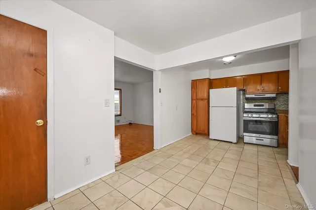 a view of a kitchen with furniture and an empty room