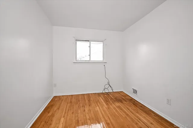 a room with a wooden floor and white walls