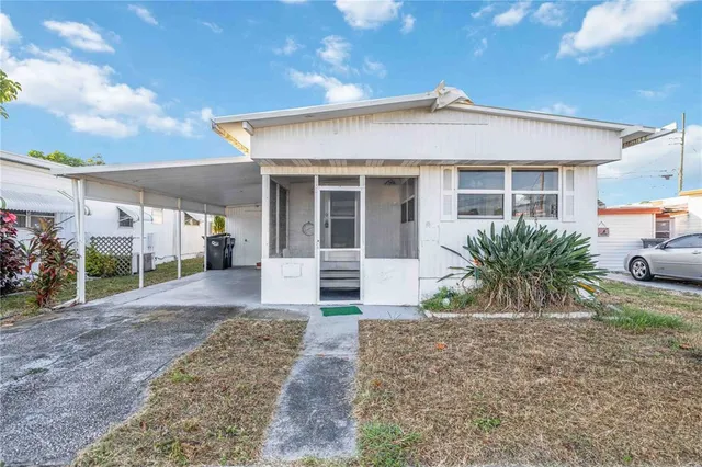 a view of a house with porch and garden