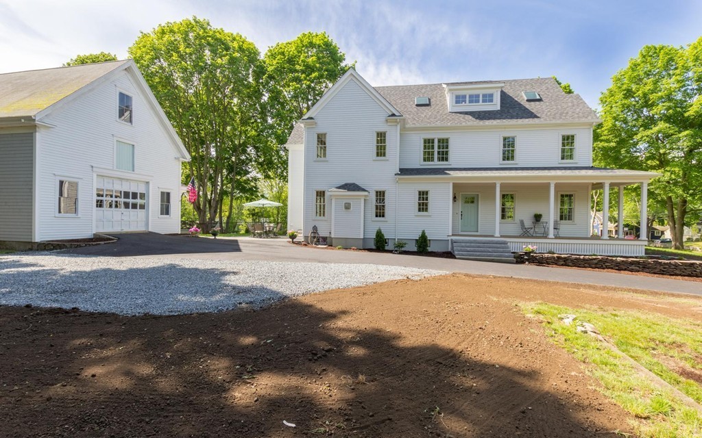 999 Main Street Hanover, MA 02339 - Photo 3 of 28 a front view of a house with a yard