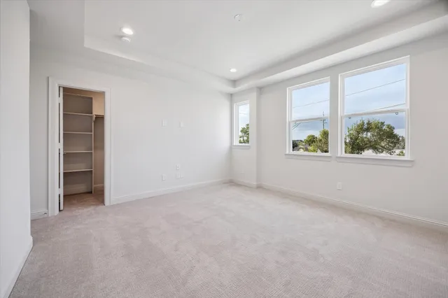 an empty room with windows and closet