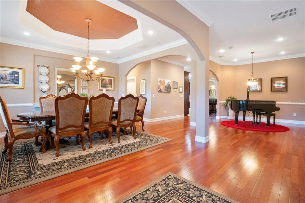 5785 Gilliam Road Orlando, FL 32818 - Photo 11 of 100 a view of a dining room with furniture a chandelier and wooden floor