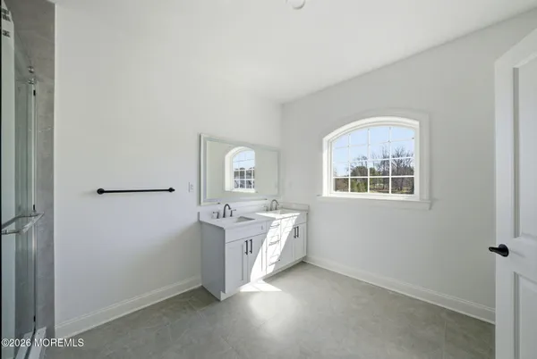 an empty room with a window and cabinet