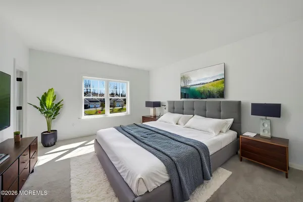 a bedroom with a bed and a potted plant