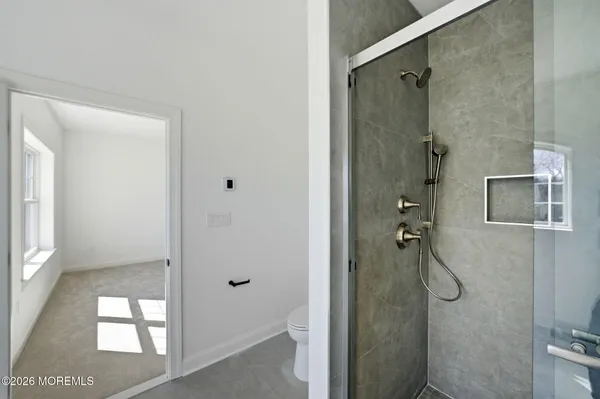 a bathroom with a glass shower door