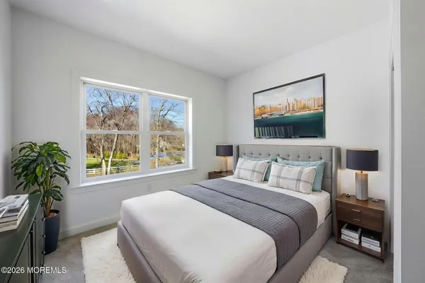a bedroom with a bed and a large window