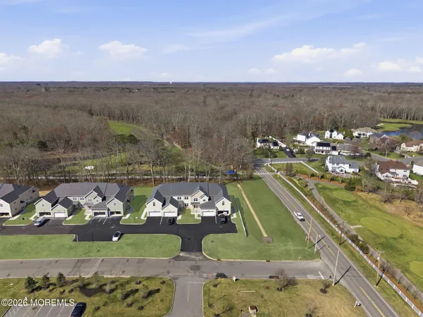 an aerial view of a house with a yard and lake view