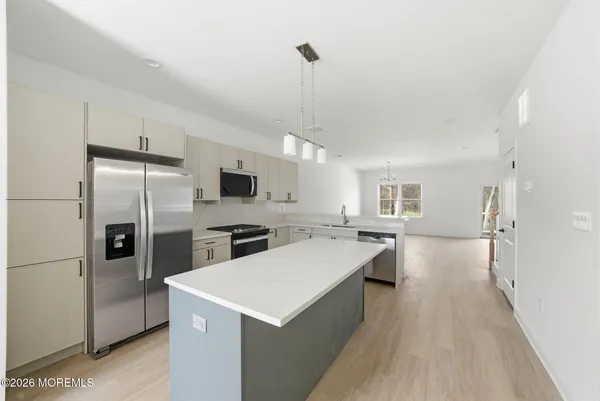 a kitchen with a refrigerator a sink and a stove
