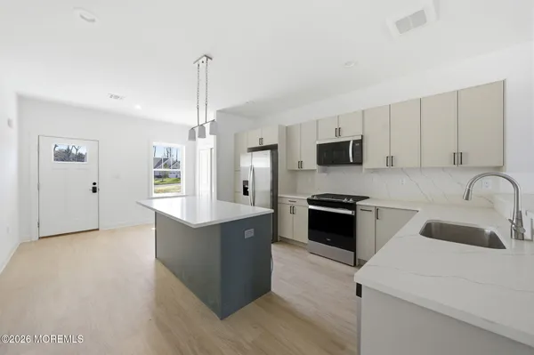 a kitchen with stainless steel appliances granite countertop a stove top oven a sink and a granite counter tops