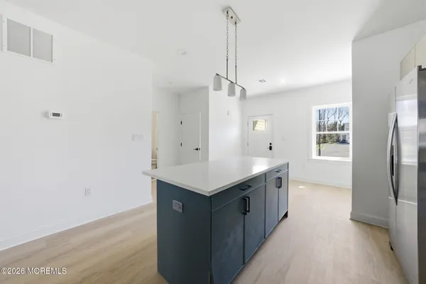 a kitchen with stainless steel appliances granite countertop a refrigerator a sink and a stove