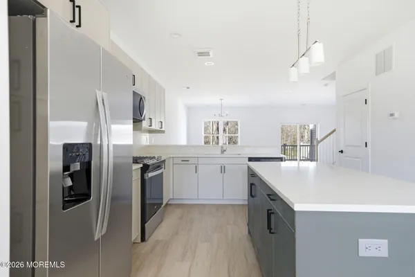 a kitchen with cabinets and stainless steel appliances