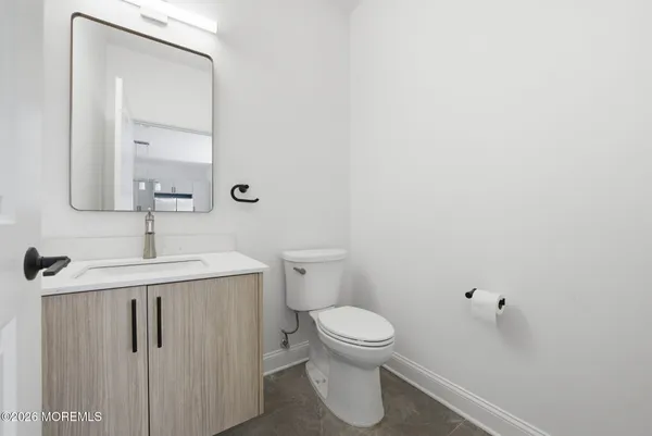 a bathroom with a sink a toilet and mirror