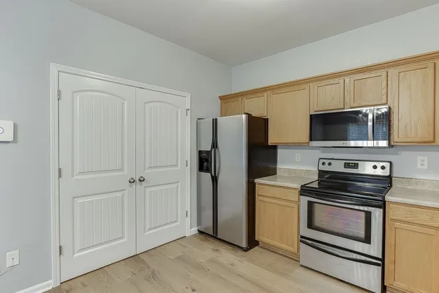 a kitchen with a refrigerator stove and microwave