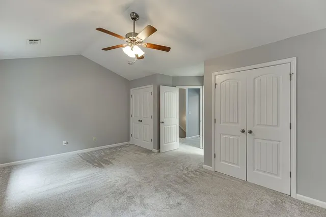a view of an empty room with a fan