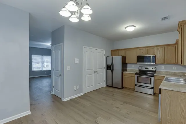 a view of a kitchen with a stove cabinets and wooden floor