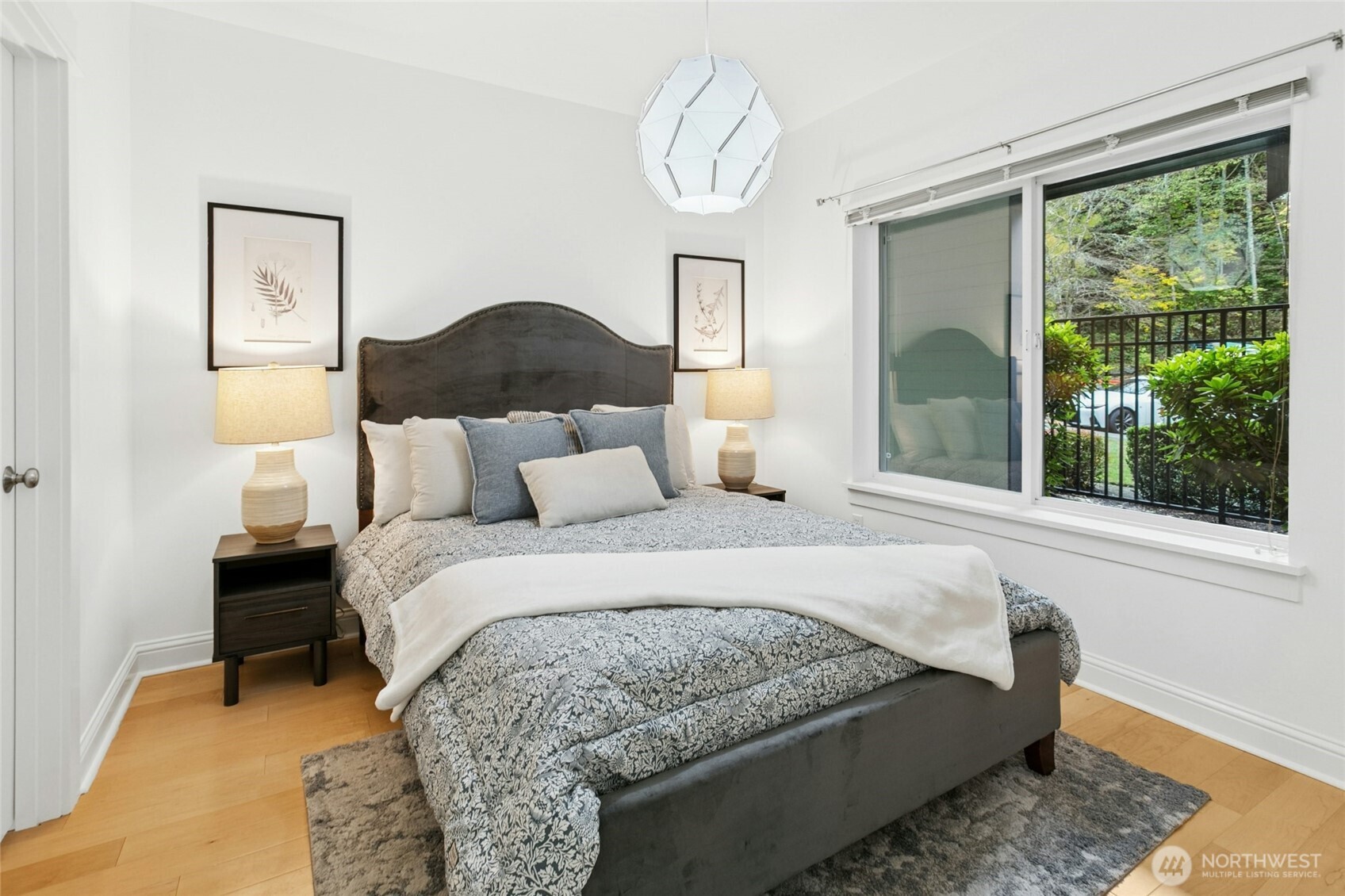 18707 Southeast Newport Way, Unit 102 Issaquah, WA 98027 - Photo 18 of 34 a bed sitting in a bedroom next to a window