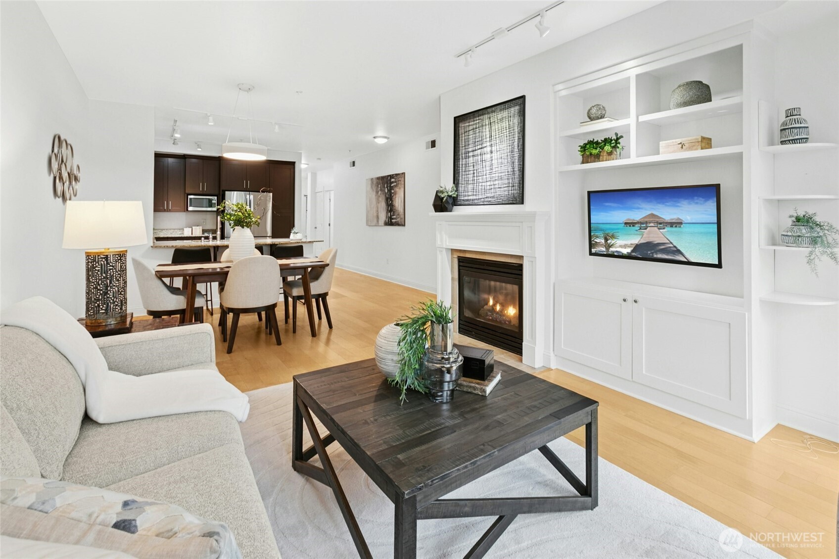18707 Southeast Newport Way, Unit 102 Issaquah, WA 98027 - Photo 5 of 34 a living room with furniture a fireplace and a flat screen tv